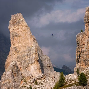Adventure seeker high wire walking in Cinque Torri, Belluno, Dolomites, Italy, Europe