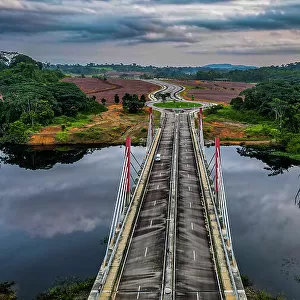 Aerial of a bridge cutting through the jungle to the future capital Ciudad de la Paz, Rio Muni, Equatorial Guinea, Africa