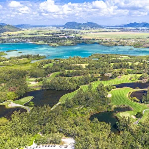 Aerial by drone of golf courses in the lush vegetation of the tropical lagoon, Ile