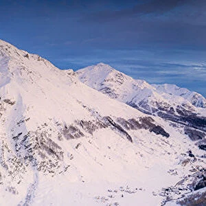 Aerial panoramic by drone of Madesimo and Andossi during a winter sunset, Valchiavenna