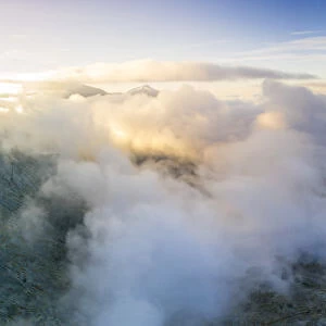 Aerial panoramic of sea of clouds over Pizzo Tambo and bends of the Spluga Pass road