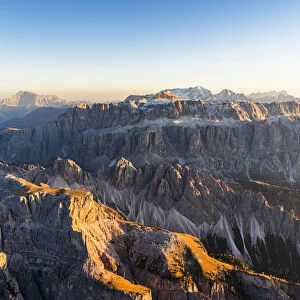 Aerial view of autumn sunset on rocky peaks of Sella Group, Val Gardena, Val di Fassa