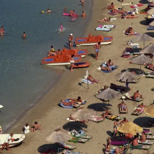 Aerial view over boats and people on a crowded beach