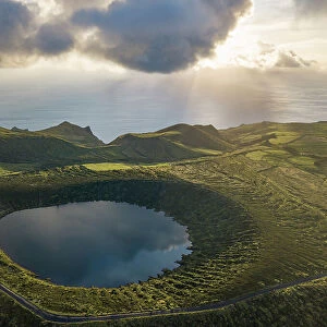 Aerial view of Caldeira Rasa lake on Flores island and the sunset over the sea, Azores islands, Portugal, Atlantic, Europe