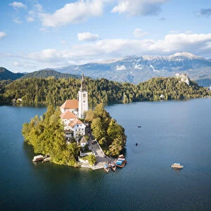 Aerial view by drone of Bled Island with the Church of the Assumption at dawn, Lake Bled