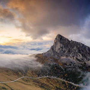 Aerial view by drone of foggy sky at sunset over Ra Gusela and Giau Pass in autumn