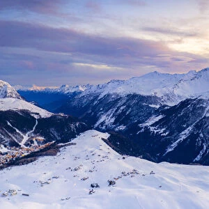 Aerial view by drone of sunset on the snowy peaks surrounding Madesimo and Andossi