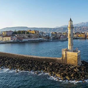 Aerial view of lighthouse and harbour of Chania old town at sunrise, island of Crete