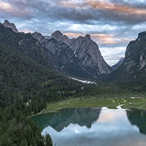 Aerial view of mountains reflected in lake Dobbiaco at sunset, Dobbiaco (Toblach)