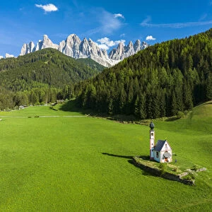 Aerial view of the Odle and iconic chapel of St. John in Ranui in spring, St. Magdalena, Funes Valley, Dolomites, South Tyrol, Italy, Europe