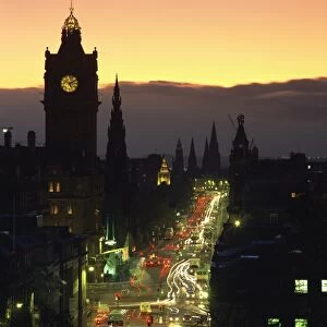 Aerial view over Princes Street at dusk, including the silhouetted Waverley Hotel clock tower