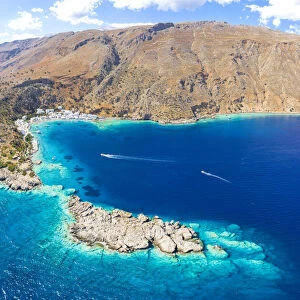 Aerial view of the village of Loutro nestled in the idyllic cove washed by turquoise sea, Crete island, Greek Islands, Greece, Europe