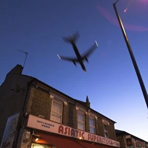 Aeroplane above shop, Hounslow, Greater London, England, United Kingdom, Europe