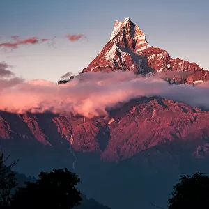 Anapurna peak over the clouds deep in the Himalayas at sunrise, Australian Camp, Nepal, Asia