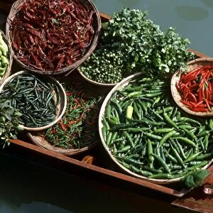 An assortment of chillies, a staple ingredient of Thai cooking, on sale on a boat in a floating market in Thailand, Southeast