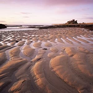 Bamburgh castle and Bamburgh beach at sunrise, Bamburgh, Northumberland