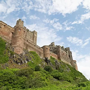 Bamburgh Castle, a hilltop fortress constructed on top of a craggy outcrop of volcanic dolerite, Grade I Listed Building, Bamburgh, Northumberland, England, United Kingdom, Europe