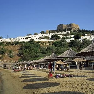 The beach below the white houses and acropolis of Lindos Town
