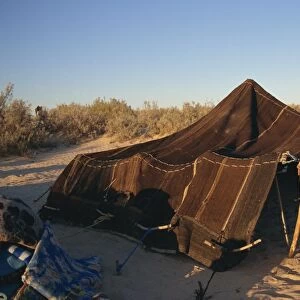 Berber guides erecting traditional tent
