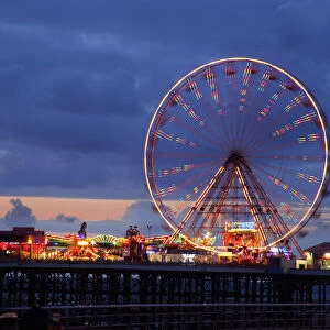 Big wheel and funfair on Central Pier lit at dusk, Blackpool Illuminations, Blackpool
