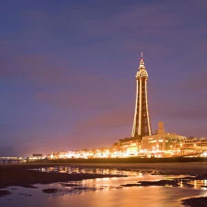 Blackpool Tower reflected on wet beach at dusk, Blackpool, Lancashire, England