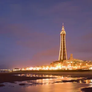 Blackpool Tower reflected on wet beach at dusk, Blackpool, Lancashire, England