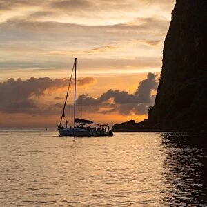 Boat moored at the base of Petit Piton near Sugar Beach at dusk, St. Lucia, Windward Islands