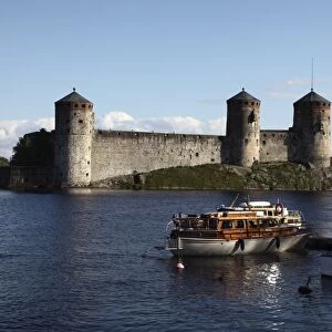 Boat moored in front of Olavinlinna Medieval Castle (St. Olafs Castle)