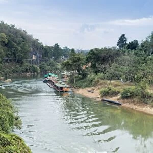 A boat on the River Kwai with the POW-built Wampoo Viaduct behind, Death Railway near Nam Tok