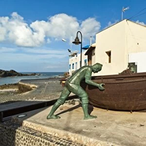 Boat with statues of fishermen at the old harbour in this north west coast village, El Cotillo, Fuerteventura, Canary Islands, Spain, Atlantic, Europe
