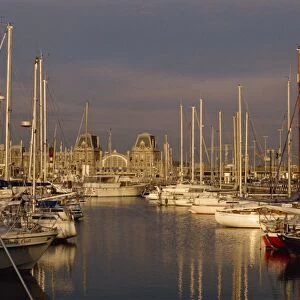 Boats in the harbour and the railway station behind in Ostend, Belgium, Europe