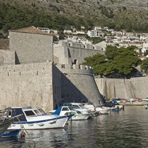 Boats moored in the shelter of the walls of the Old City, Dubrovnik, UNESCO World Heritage Site, Croatia, Europe