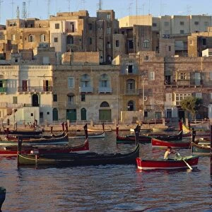 Boats moored in Valletta harbour at dusk