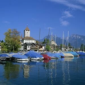 Boats on the water and the town of Spiez on Lake Thunersee in the Bernese Oberland