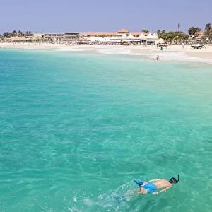 Boy snorkelling off the sandy beach in Santa Maria, Praia de Santa Maria, Baia de Santa Maria