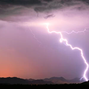 A bright lightning strike illuminating the Buckeye Foothills in Arlington during