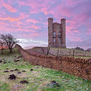 Broadway Tower and Cotswold drystone wall at sunrise, Broadway, Cotswolds, Worcestershire
