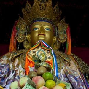Buddha with sacrifical offerings in a little temple in Lhasa, Tibet, China, Asia