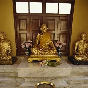 Buddha statues covered in gold leaf