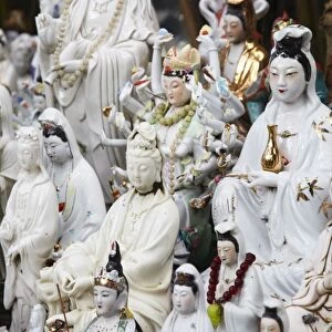 Buddhist figurines at shrine in bamboo forest, Quarry Bay, Hong Kong, China, Asia