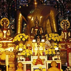 Buddhist monks worshipping inside temple