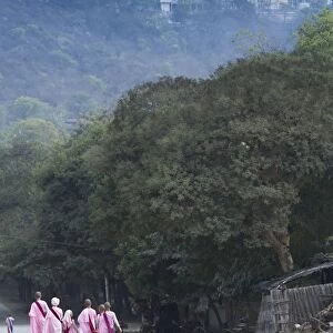 Buddhist nuns in traditional robes with the stupas of Sagaing in the distance, Sagaing