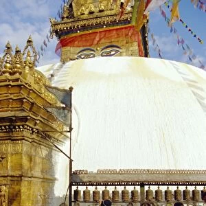 Buddhist stupa and believers spinning prayer wheels