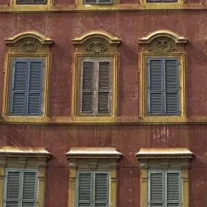 Building facade with shutters on windows on the Piazza di Spagna
