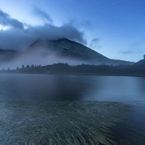 Calm water of Hopschusee lake during blue hour, Simplon Pass, Valais Canton, Swiss Alps