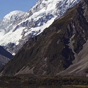 A camper van is dwarfed by Aoraki (Mount Cook)