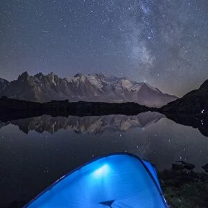 Camping with a tent under the Milky Way at Lac des Cheserys, looking at Mont Blanc