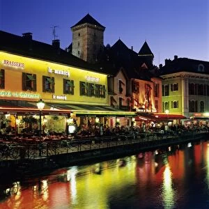 Canal side restaurants below the Chateau at dusk, Annecy, Lake Annecy, Rhone Alpes, France, Europe