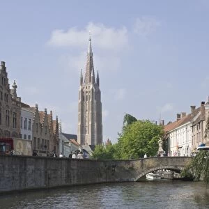 Canal scene with the spire of the Church of Our Lady, Brugge, Belgium, Europe