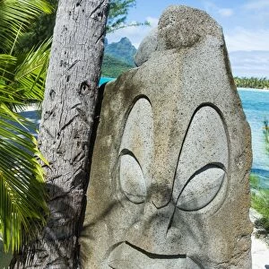 Carved stone statue on a Motu, Bora Bora, Society Islands, French Polynesia, Pacific